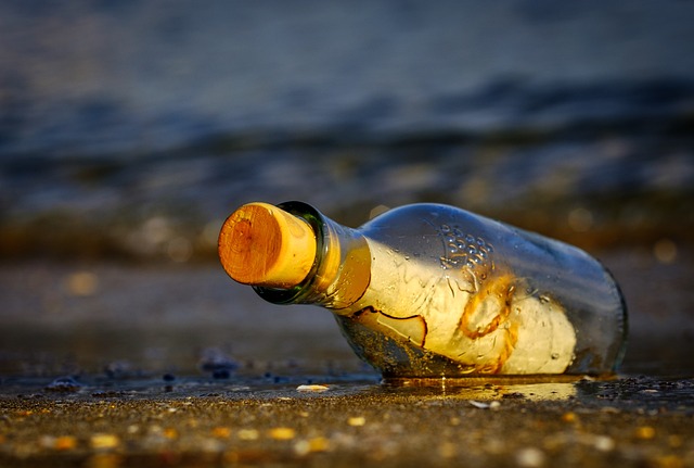 Glass bottle with a cork on the beach