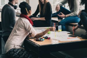 a group of people gathered around a work table