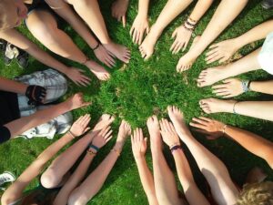 a circle of hands and feet in the grass