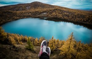 sneakers overlooking a gorgeous mountain lake